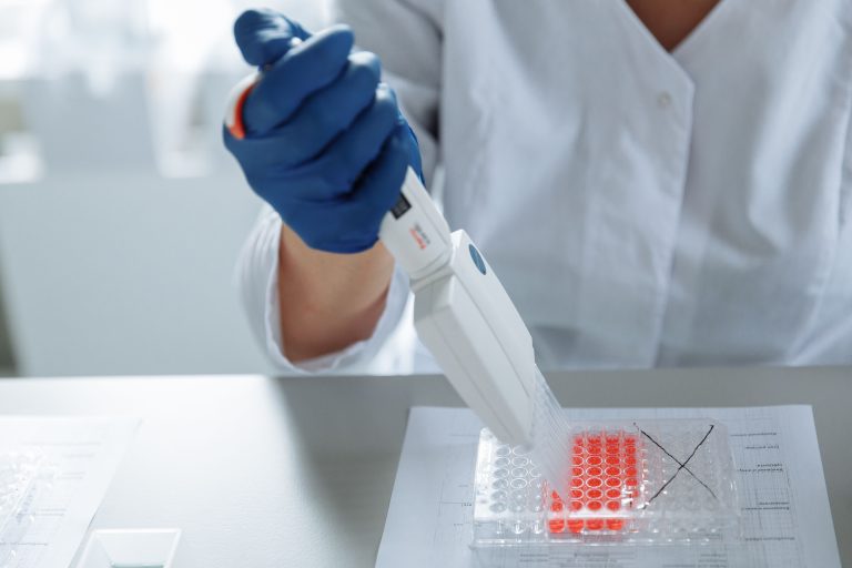 A scientist working with DNA samples in a genomics laboratory
