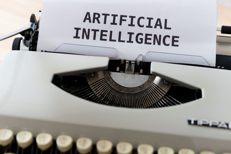 A close-up of a typewriter showcasing 'ARTIFICIAL INTELLIGENCE' on paper