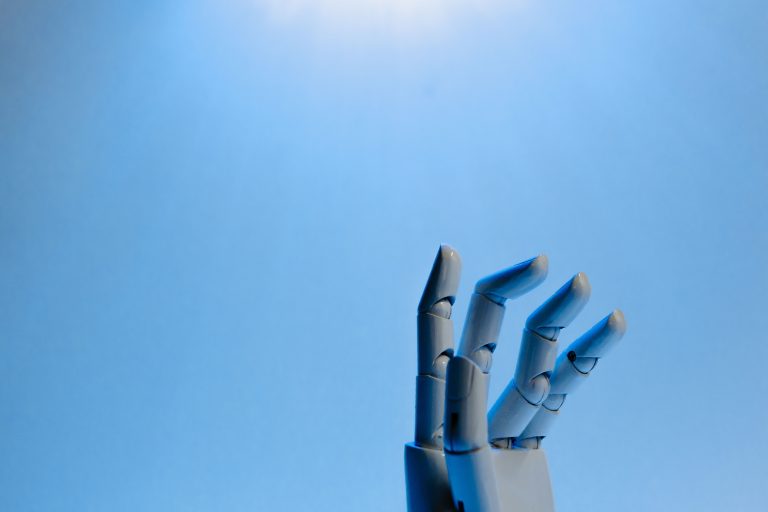 Robotic hand with articulated fingers reaching towards the sky on a blue background