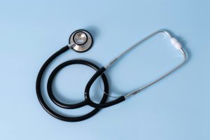 A stethoscope on a plain blue background