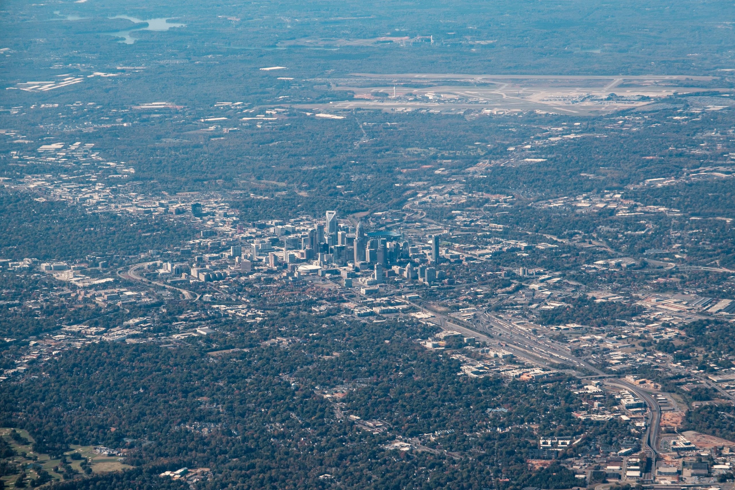 Aerial photograph showcasing the bustling skyline of Charlotte, North Carolina amidst green landscapes