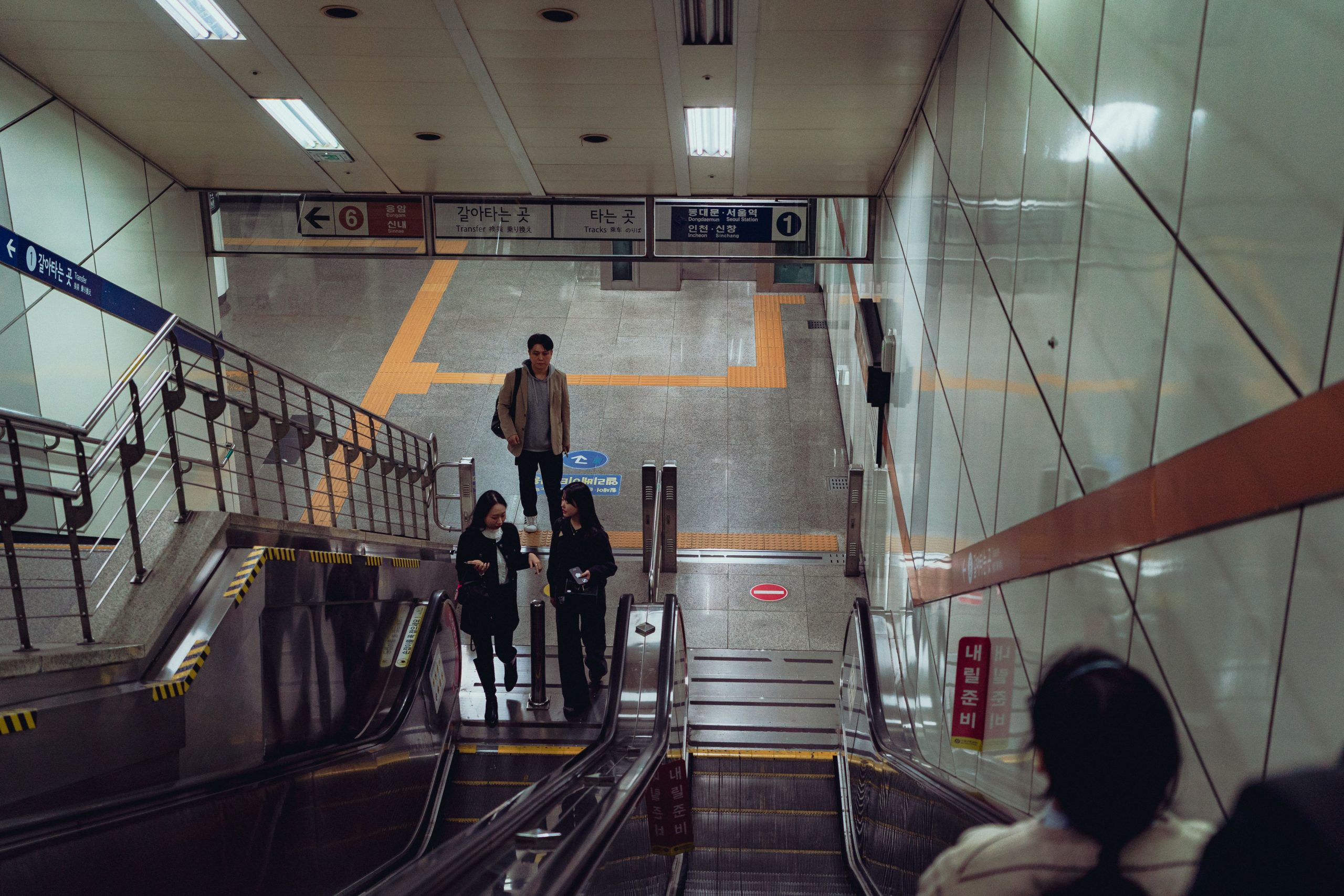 People navigating the Suwon subway station, South Korea, showcasing daily urban life