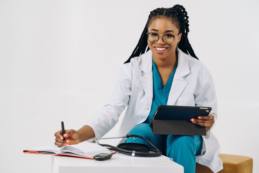 Healthcare professional holding a tablet beside a blank notebook, an illustrative digital care scene